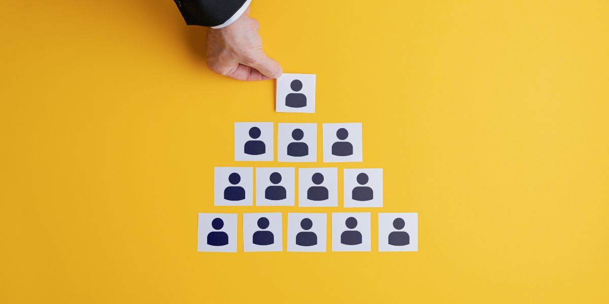 1 A person placing character icons in a pyramid shape